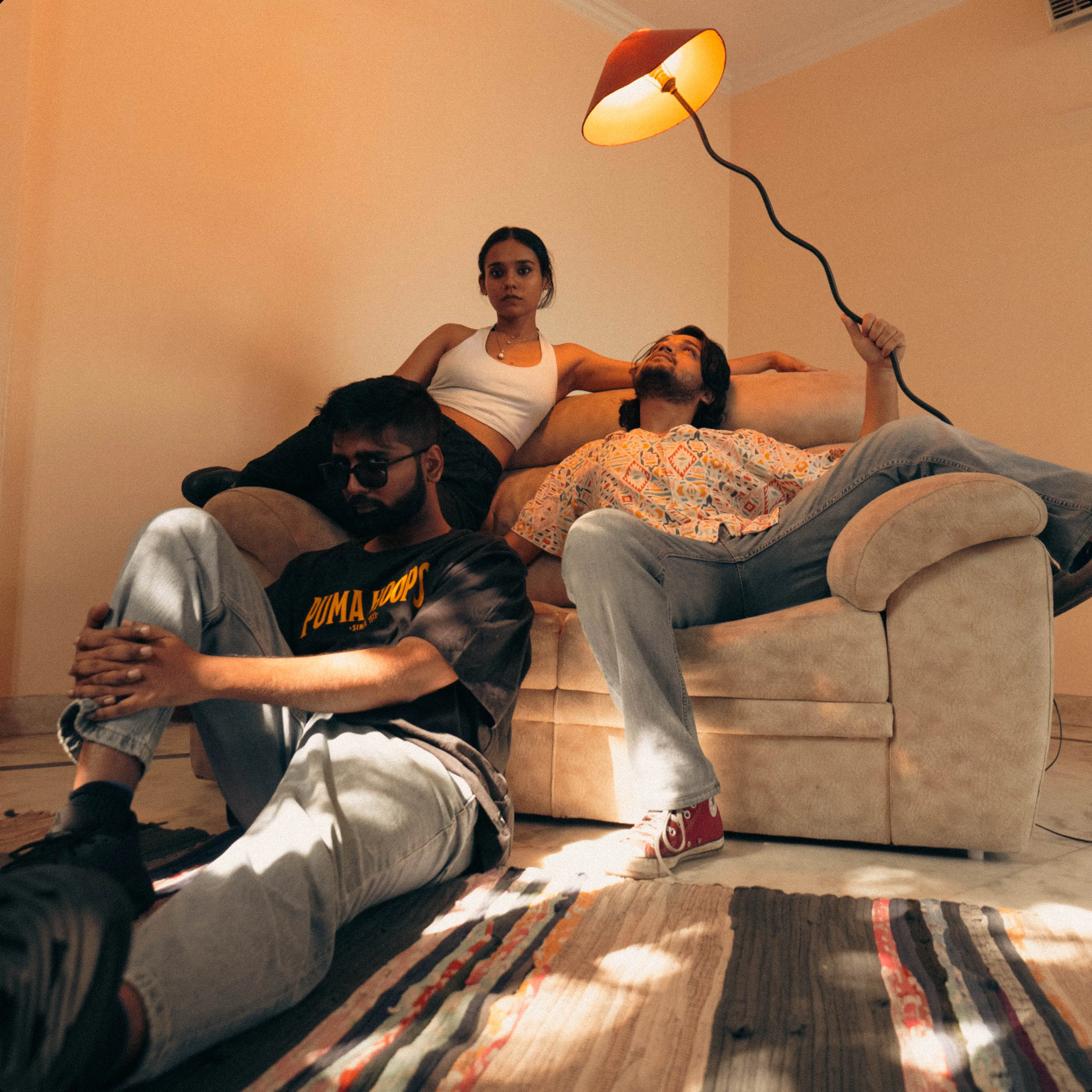The four of them squeezed onto a sofa in a warm-lit room